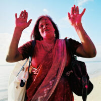 MAURITIUS,17.MAERZ02 -  Ferien auf der Insel Mauritius. Die Strandverkaeuferin Rita voller roter Farbe von einem Inder der das Holi Fest feiert.

photo by Daniel Ammann