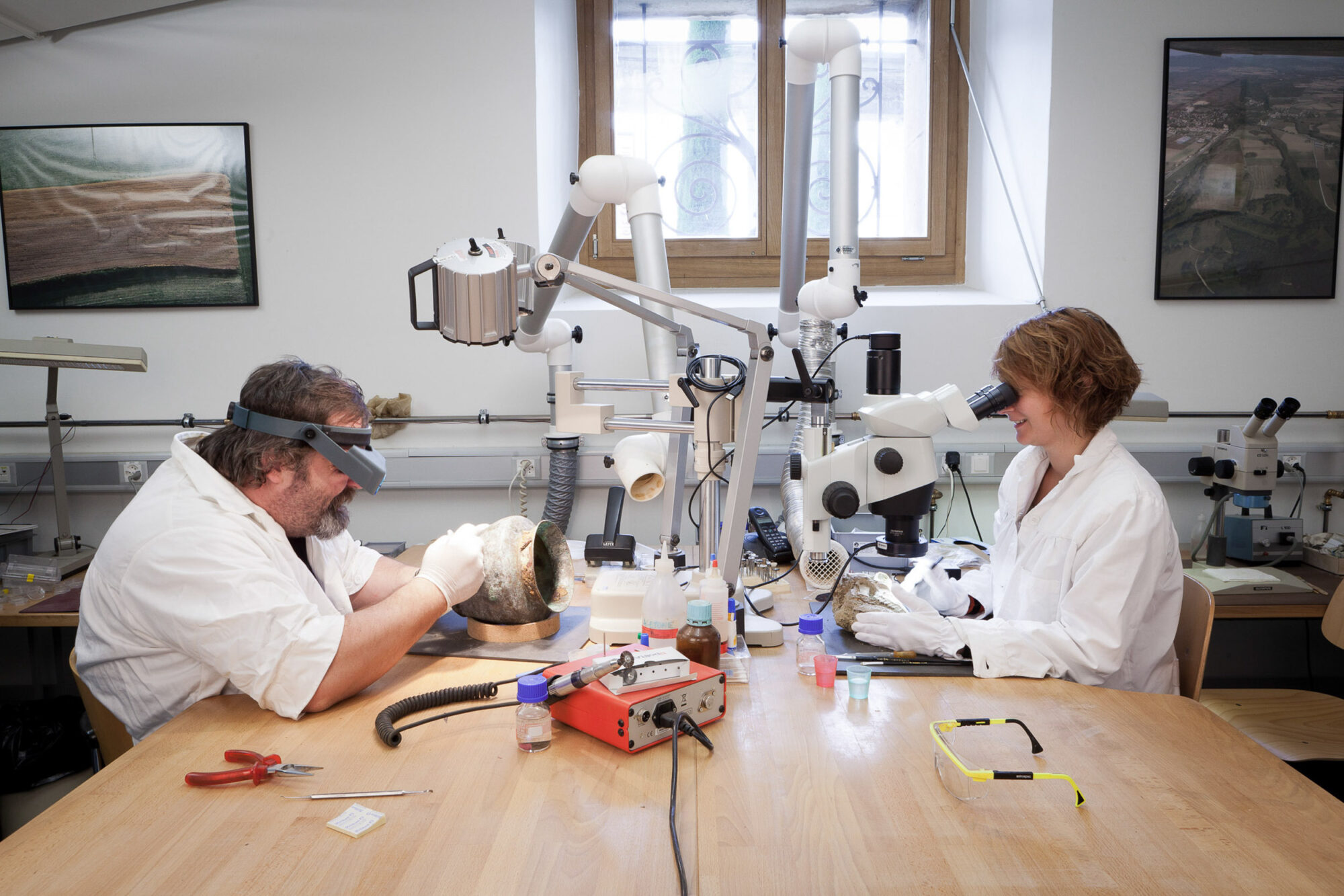 Lausanne, Wadt, 2. November 2011 - Am Kantonalen Archaeologie Museum in Lausanne bearbeitet Sandra Gilloz (rechts) einen Tierschaedel und  David Cuendet (links) ein Bronzegefaess.