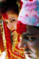 KATHMANDU 7. APRIL 2000 - Die Braut (L) schaut in Nepals Hauptstadt Kathmandu waehrend einer Traditionellen Hochzeit ihren Angetrauten (R) an.

Photo by Daniel Ammann