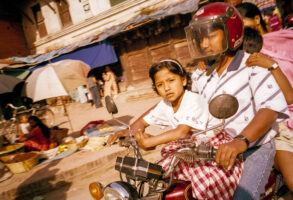 KATHMANDU 21. APRIL 2000 - Eine Familie in Nepals Hauptstadt Kathmandu faehrt auf einem Toeff durch die Strasse.

Photo by Daniel Ammann